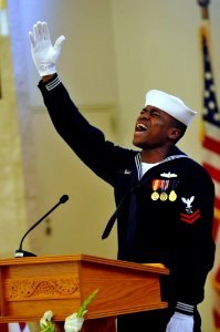 US Navy 110506-N-WW409-060 Operations Specialist 2nd Class Johnny McCaleb sings Words of Comfort during the funeral service for Cryptologic Technic