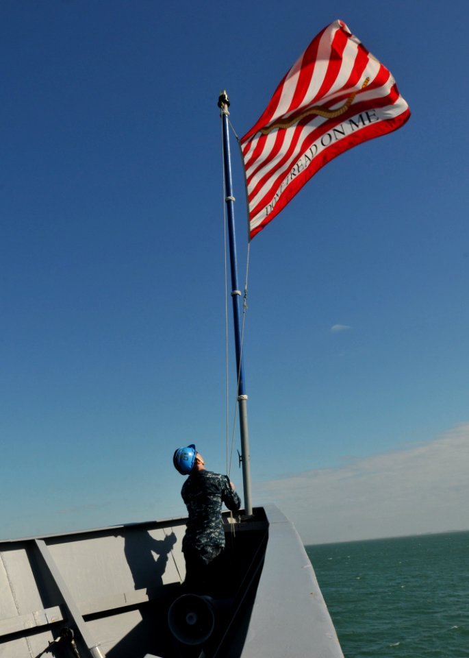 US Navy 110508-N-NL541-051 Seaman Arthur Miller raises the union jack on the foc'sle as USS Thach (FFG 43) anchors off the coast of Rio Grande, Bra