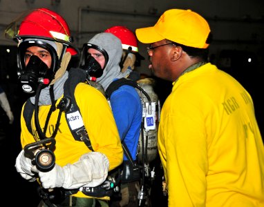 US Navy 110510-N-0074G-017 A member of the damage control training team teaches Sailors how to properly fight a simulated class Bravo fire during a