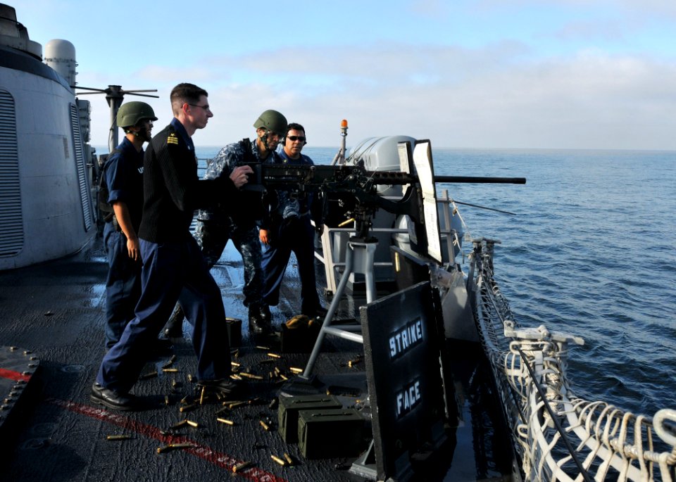 US Navy 110511-N-NL541-303 Cmdr. Jeffrey Scudder, commanding officer of the guided-missile frigate USS Thach (FFG 43), fires a .50-caliber machine