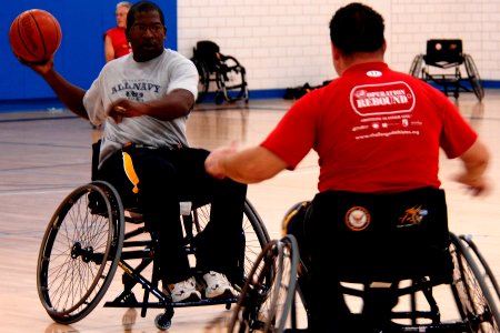 US Navy 110510-N-CD297-009 Retired Chief Operations Specialist Gerald Wayne Williams demonstrates wheelchair handling techniques during basketball
