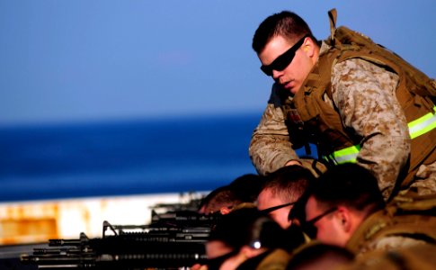 US Navy 110510-N-OS574-257 Cpl. Zachary Roepknack acts as a line coach during a small arms qualification aboard USS Mesa Verde (LPD 19)