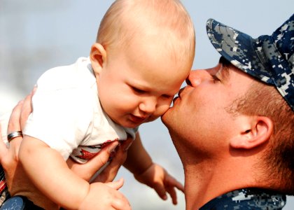 US Navy 110510-N-DU438-098 Fire Controlman 2nd Class Geoffrey J. Bourget, assigned to the guided-missile cruiser USS Gettysburg (CG 64), kisses his