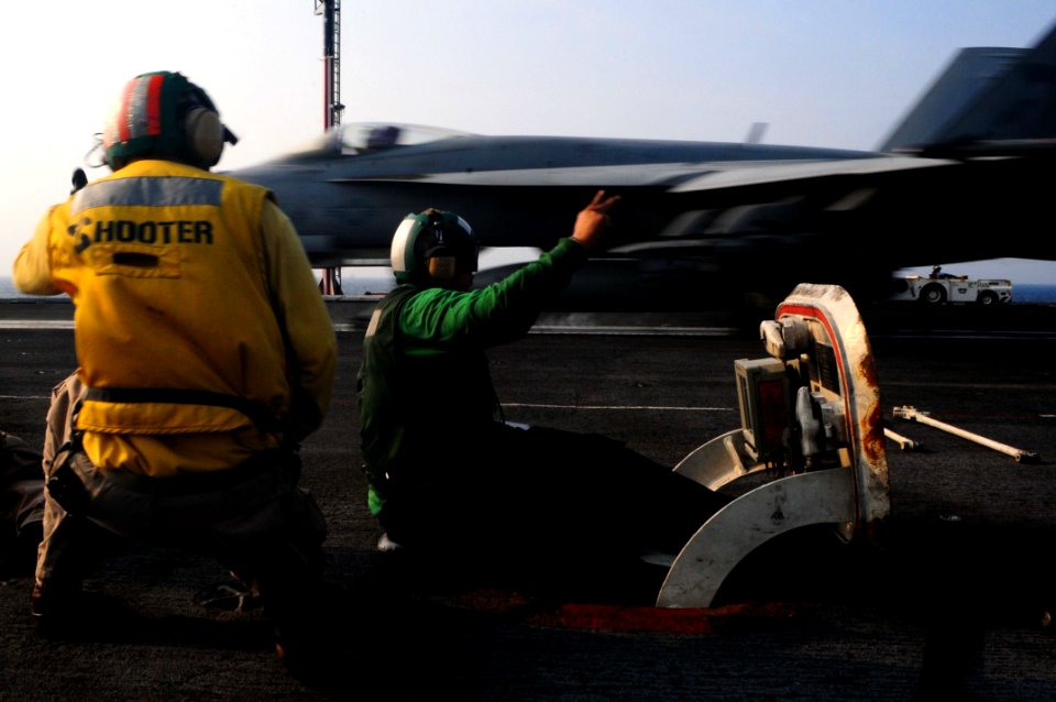 US Navy 110507-N-UO379-024 Aviation Boatswain's Mate (Equipment) Airman Adrian Iglesia signals the catapult is properly calibrated to launch an F-A