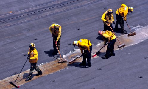 US Navy 110510-N-0074G-001 Sailors assigned to the aircraft carrier USS Enterprise (CVN 65) scrub the guidelines on the flight deck to make them mo