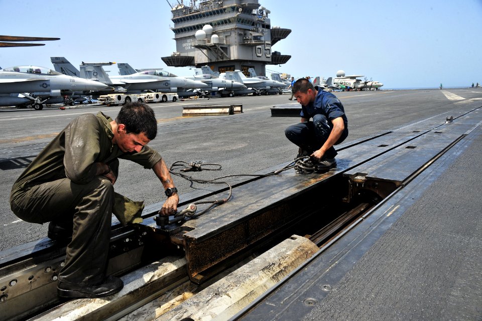 US Navy 110513-N-0074G-018 Sailors assigned to the aircraft carrier USS Enterprise (CVN 65) perform maintenance on a catapult during a no-fly day