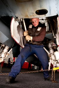 US Navy 110510-N-BT887-003 Aviation Electronics Technician Airman Zac Winking pumps the auxiliary hangar unit of an F-A-18C Hornet aboard USS John