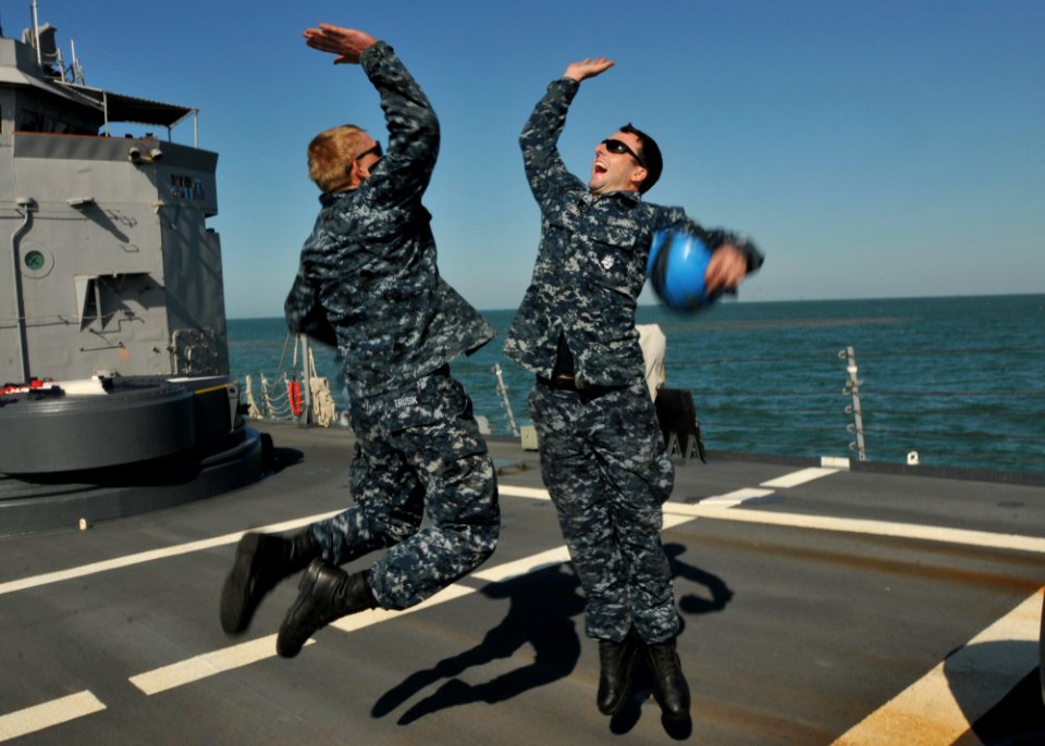 US Navy 110508-N-NL541-139 Seaman Michael Trusik and Seaman Arthur Miller celebrate after completing a successful anchoring detail off the coast of