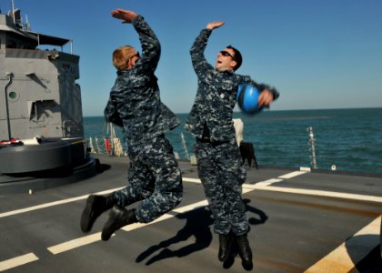 US Navy 110508-N-NL541-139 Seaman Michael Trusik and Seaman Arthur Miller celebrate after completing a successful anchoring detail off the coast of