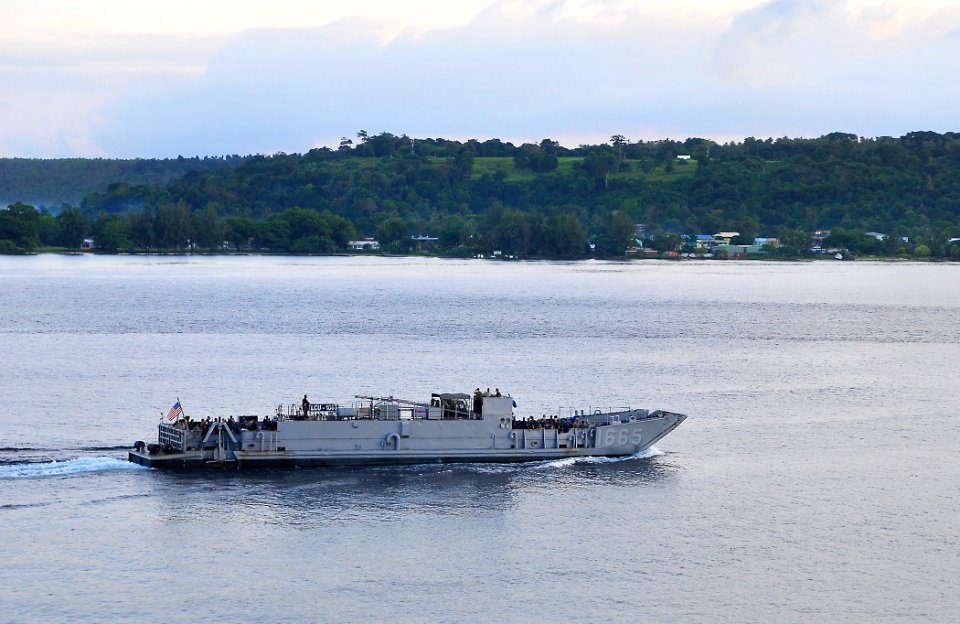 US Navy 110508-N-KB563-003 Service members and nongovernmental organization personnel ride in Landing Craft Utility (LCU) 1665 while en route to sh