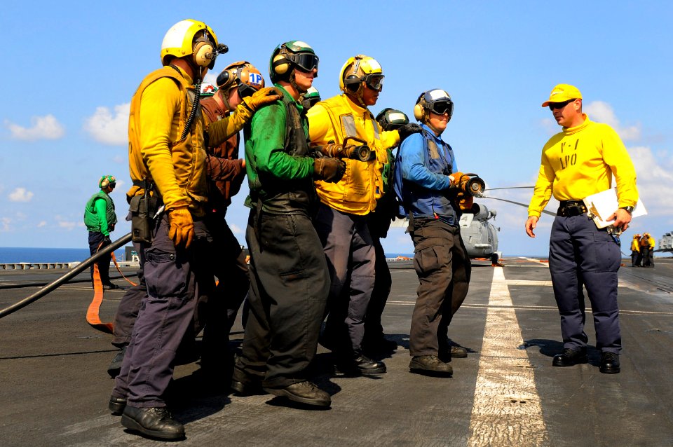 US Navy 110511-N-OK922-540 Sailors simulate fighting an aircraft fire during a mass casualty drill on the flight deck of USS Carl Vinson (CVN 70)