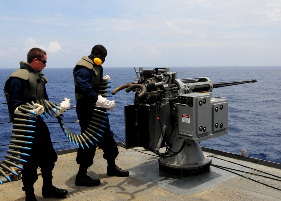 US Navy 110511-N-UE250-015 Gunner's Mate Seaman Recruit Cody Byquist and Gunner's Mate 1st Class Jerome Claybron load training rounds into a Mark 3