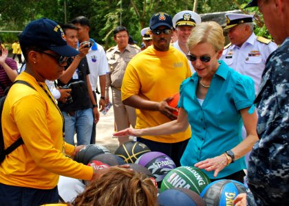 US Navy 110512-N-VP123-131 U.S. Ambassador to Thailand Kristie Kenney helps Sailors embarked aboard the amphibious dock landing ship USS Tortuga (L photo