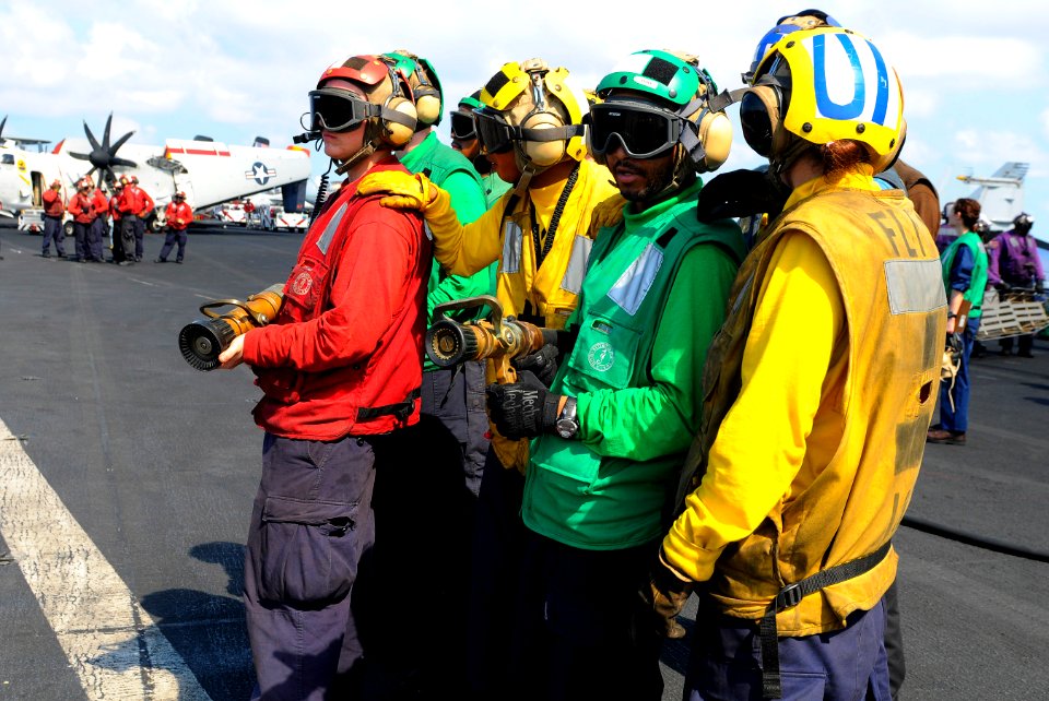 US Navy 110511-N-OK922-597 Sailors simulate fighting an aircraft fire during a mass casualty drill on the flight deck of USS Carl Vinson (CVN 70)