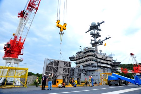 US Navy 110510-N-MH885-006 Workers at the Yokosuka ship repair facility remove the SPS-48E three-dimensional air search radar from the tower of the
