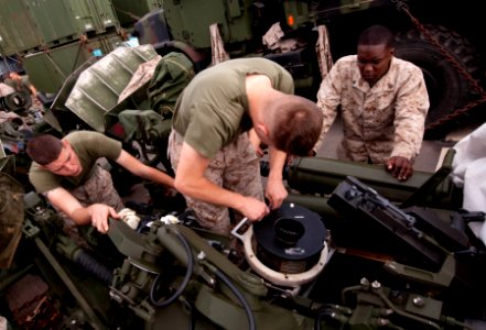 US Navy 110510-N-QP268-319 Marines perform routine maintenance on an M777 A2 Howitzer aboard USS Whidbey Island (LSD 41)