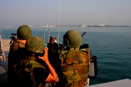 US Navy 110513-N-SP676-378 Information Systems Technician 2nd Class Herman Bennett points out the naval base to Quartermaster Seaman Joshua Kissel