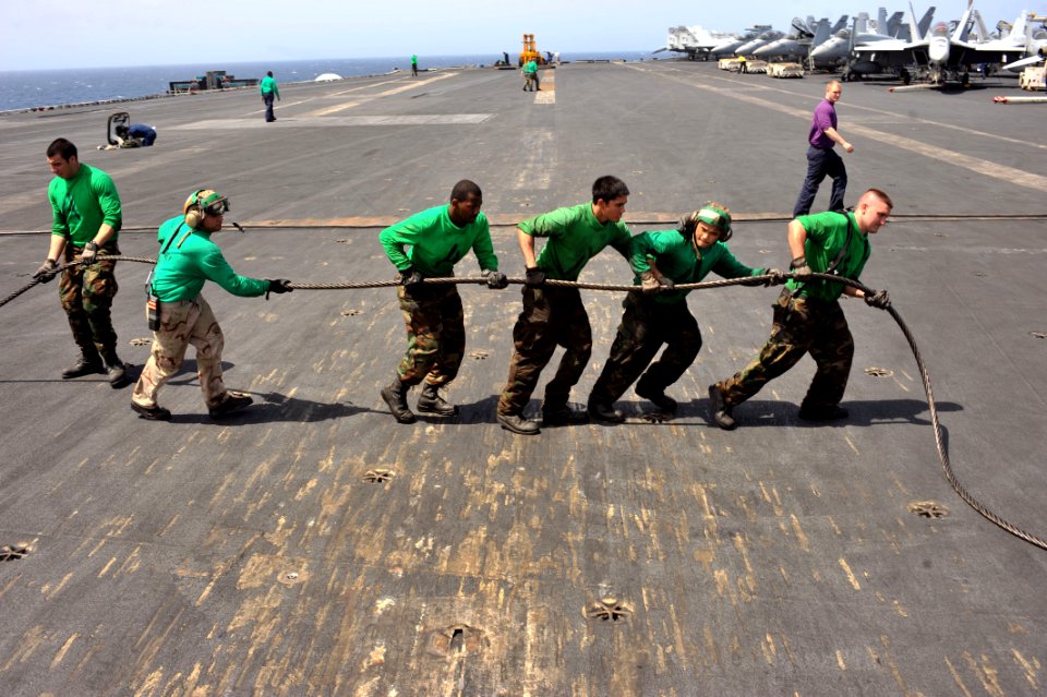 US Navy 110513-N-0569K-018 Sailors assigned to the air department aboard the aircraft carrier USS Enterprise (CVN 65) reweave the three wire on the
