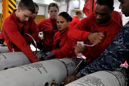 US Navy 110512-N-1004S-054 Aviation Ordnancemen work together during a GBU-54 bomb assembling evolution aboard USS Ronald Reagan (CVN 76)