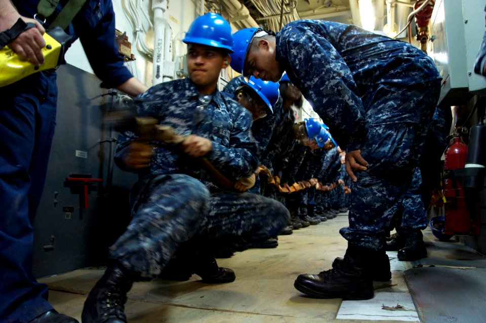 US Navy 110512-N-ZC343-037 Sailors aboard the amphibious assault ship USS Bonhomme Richard (LHD 6) practice hose handling techniques during a main