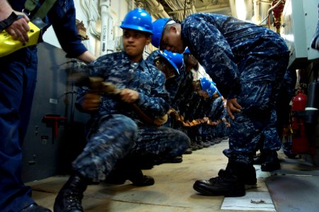 US Navy 110512-N-ZC343-037 Sailors aboard the amphibious assault ship USS Bonhomme Richard (LHD 6) practice hose handling techniques during a main