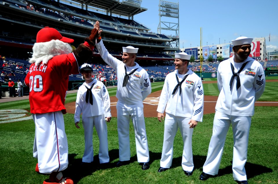 US Navy 110515-N-AD372-286 Washington Nationals mascot Screech high fives Hospital Corpsman 1st Class Andrew Jenkins at the Nationals Park prior to