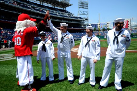 US Navy 110515-N-AD372-286 Washington Nationals mascot Screech high fives Hospital Corpsman 1st Class Andrew Jenkins at the Nationals Park prior to