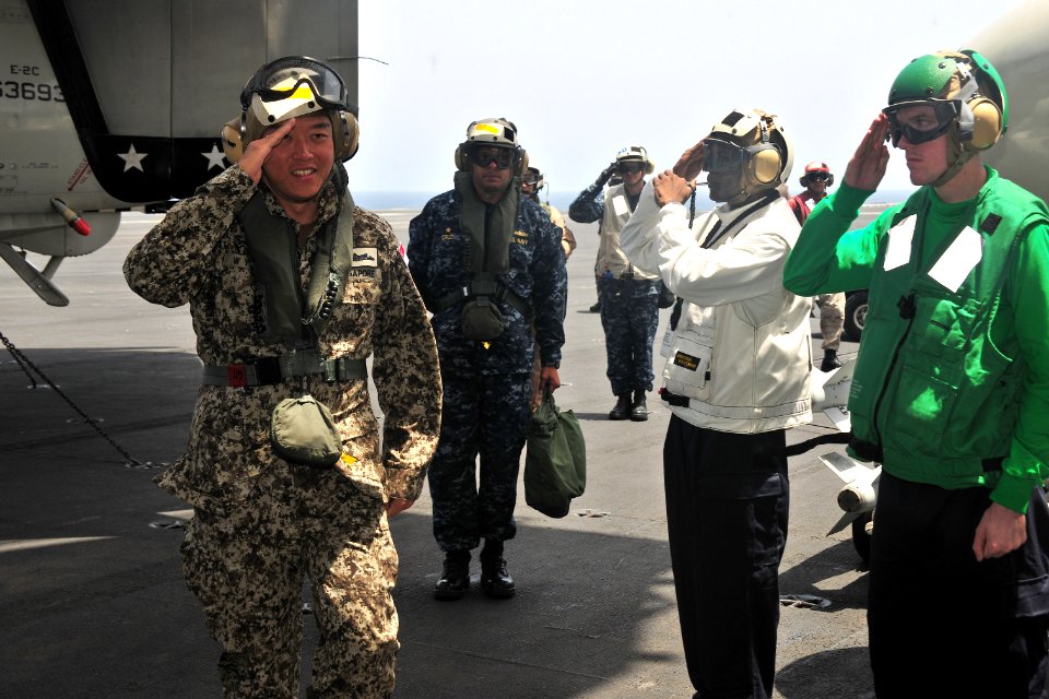 US Navy 110512-N-0074G-001 Singapore navy Rear Adm. Harris Weng Yip Chan, commander of Combined Task Force (CTF) 151, salutes rainbow sideboys as h