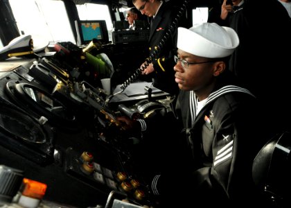 US Navy 110513-N-NL541-022 Yeoman Seaman Johnny English acts as the master helmsman, piloting the guided-missile frigate USS Thach (FFG 43) as Thac
