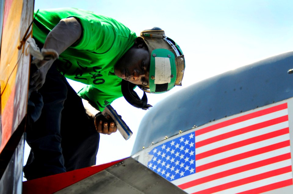 US Navy 110511-N-OK922-382 ircrew Survival Equipmentman 3rd Class Travis Fowler cleans a C-2A Greyhound on the flight deck of USS Carl Vinson (CVN