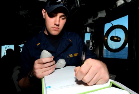 US Navy 110513-N-TB177-057 nsign Ross F. Hammerer, the communications officer aboard the guided-missile destroyer USS Truxtun (DDG 103), records ra