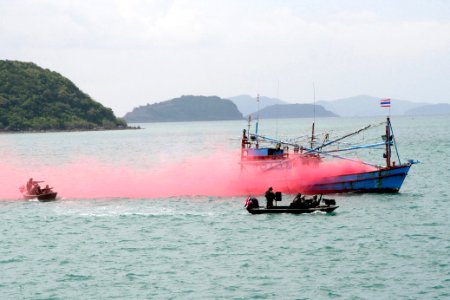 US Navy 110515-N-WL717-045 Two Royal Thai Navy assault boats simulate firing upon a fishing boat using red smoke to indicate a hit, while demonstra photo