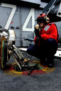 US Navy 110513-N-OY799-210 Aviation Ordnanceman Airman Bailey McCulley, from Port Charlotte, Fla., mans an upper weapons elevator on the flight dec