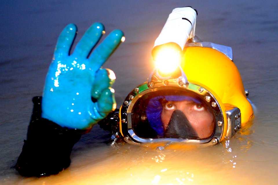 US Navy 110514-N-WL435-347 Chief Navy Diver Billy Goold gives the OK to signify his equipment is working properly before fully submerging himself u