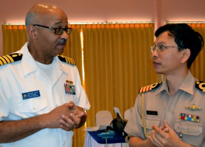 US Navy 110511-N-VA590-015 Capt. Rowland E. McCoy, left, peaks with a Royal Thai Navy doctor at a medical symposium during Cooperation Afloat Readi