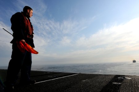 US Navy 110513-N-XE109-051 Quartermaster 3rd Class Bradley Barber watches as his watches as the ship approaches the Military Sealift Command fast c