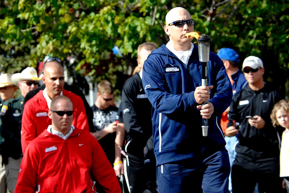 US Navy 110516-N-CD297-041 Logistic Specialist 1st Class Robert Lipscomb marches with the torch during the opening ceremony of the second annual Wa
