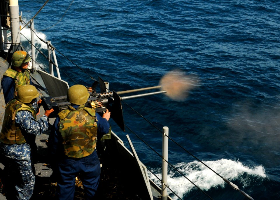 US Navy 110514-N-YM590-214 Gunner's Mate 2nd Class Charles H. Talbert fires a .50-caliber machine gun during a crew-served weapons certification ex