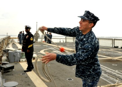 US Navy 110513-N-NL541-161 onar Technician (Geographic) 3rd Class Mohammad Suleiman throws a heaving line as the guided-missile frigate USS Thach (