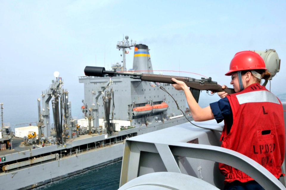 US Navy 110514-N-GW695-016 Gunner's Mate 3rd Class Amber Cooper prepares to fire a shot-line from the amphibious transport dock ship USS Green Bay