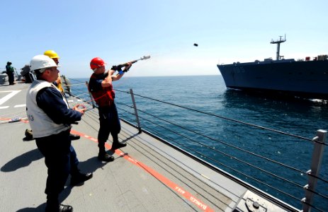 US Navy 110514-N-TB177-141 A Sailor aboard the guided-missile destroyer USS Truxtun (DDG 103) fires the messenger line