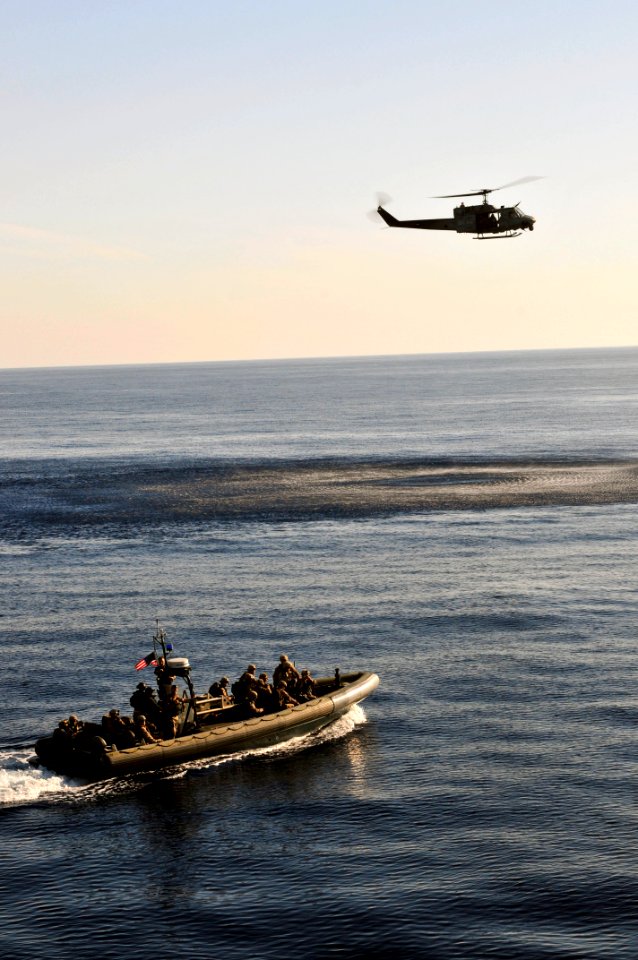 US Navy 110514-N-XO436-337 A rigid-hull inflatable boat and an UH-1N Huey helicopter assigned to the San Antonio-class amphibious transport dock sh