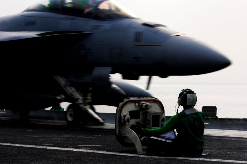 US Navy 110515-N-UO379-038 Aviation Boatswain's Mate (Equipment) Airman Aaron Jones completes final calibrations and launches an F-A-18F Super Horn