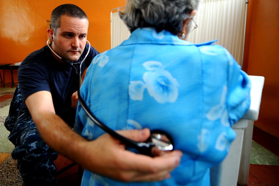 US Navy 110516-F-CF975-075 Lt. Cmdr. Brad Serwer listens to a patient's lungs at the Escuela Don Bosco medical site during Continuing Promise 2011