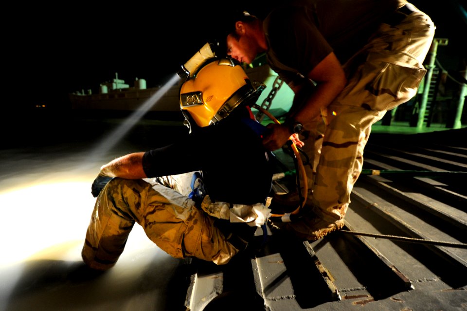 US Navy 110514-N-WL435-079 Hospital Corpsman 1st Class Chris Precht maintains positive control of Navy Diver 1st Class Dean Bates until Bates recei