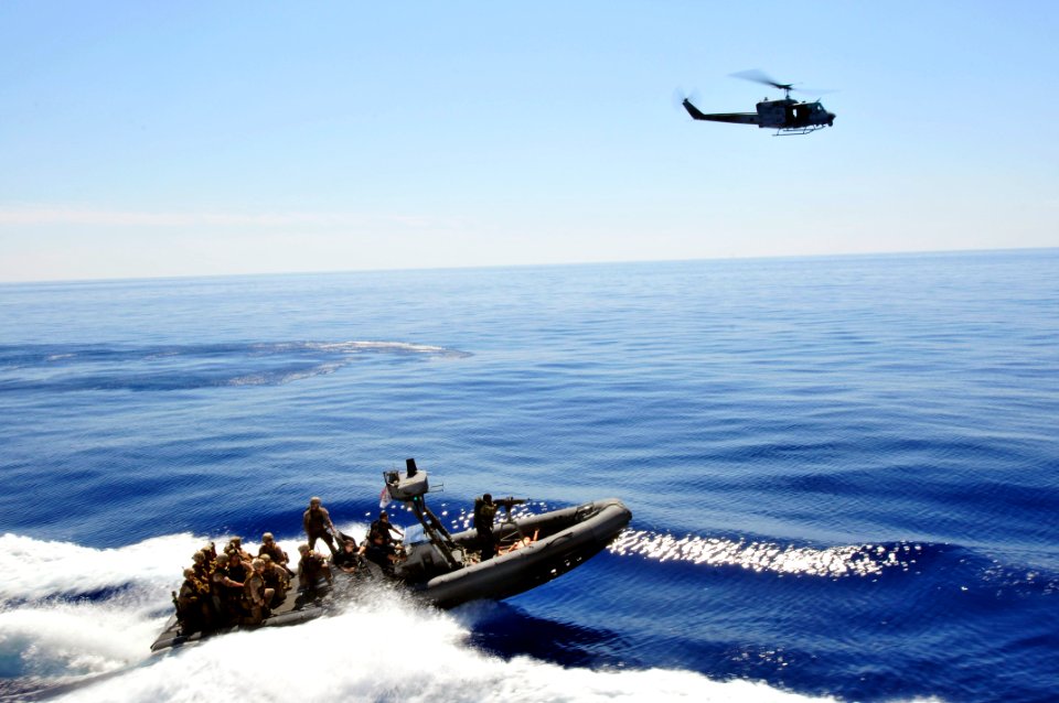 US Navy 110514-N-XO436-241 A rigid-hull inflatable boat and an UH-1N Huey helicopter assigned to the San Antonio-class amphibious transport dock sh