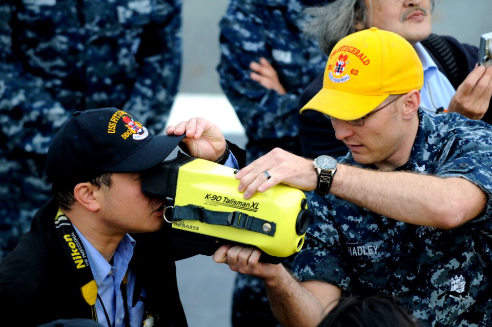 US Navy 110517-N-ER662-274 Damage Controlman 1st Class Branden Hadley gives a demonstration of equipment used during fires to Japanese media aboard