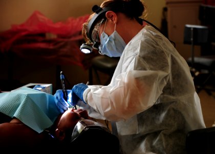 US Navy 110516-N-QD416-121 Hospital Corpsman 1st Class Kimberly Edwards, from Louisville, Ky., cleans the teeth photo