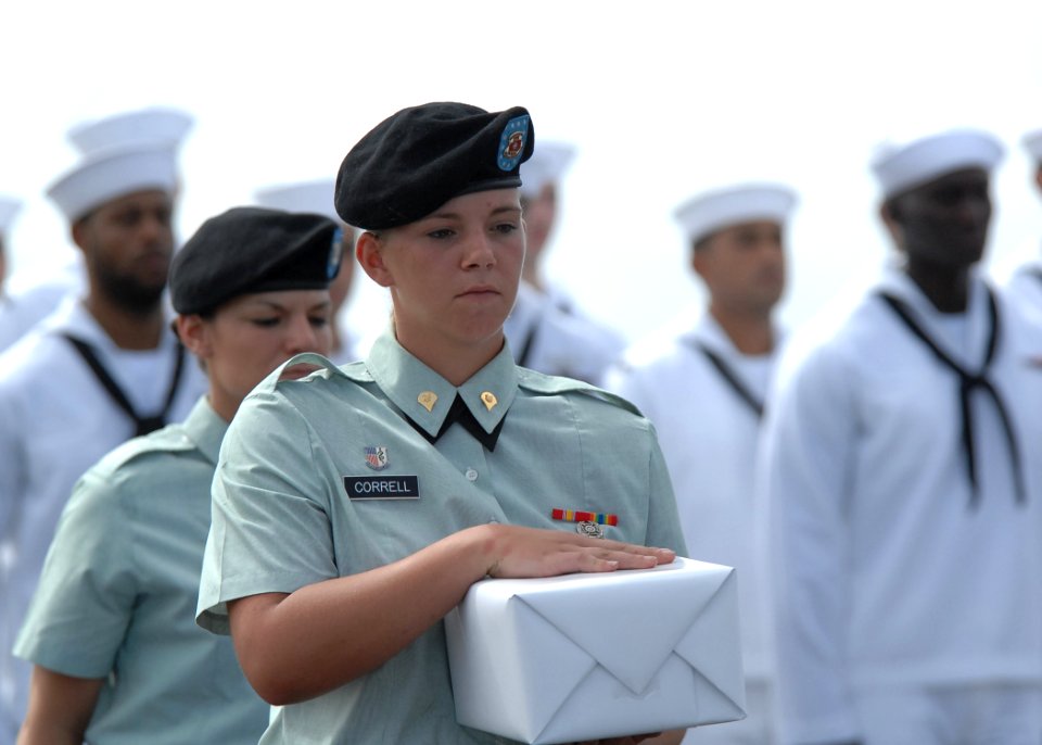 US Navy 110518-N-YM863-133 Spc. Heather Correll holds remains to be committed to the sea during a burial at sea ceremony aboard the amphibious tran