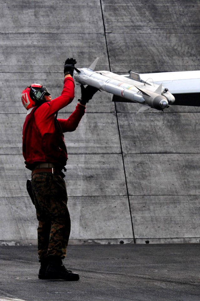 US Navy 110515-N-UO379-061 Lance Cpl. Vincent Johnson erforms a pre-flight inspection of an AIM-9 Sidewinder missile attached to an F-A-18C Hornet